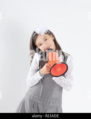 little girl with a red megaphone .isolated on white background Stock Photo