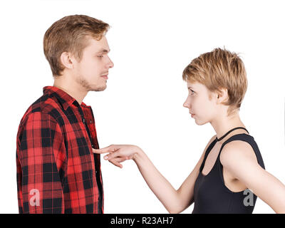 Young couple communication. Woman pointing or asking something to her boyfriend and man listening to her. Isolated on white Stock Photo