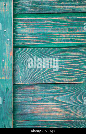Background of wooden textured boards with a vertical plank with traces of green paint. Vertical. Stock Photo