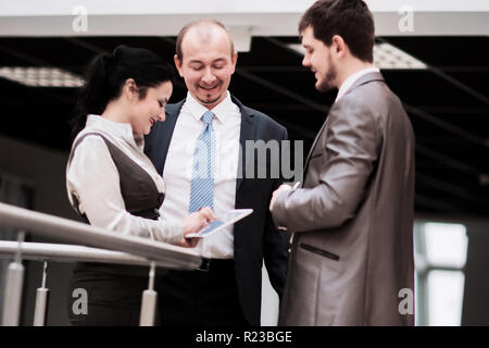 smiling business team discussing something in the office Stock Photo