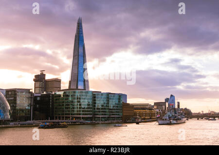 View towards South London with the Shard skyscraper, the city Hall and HMS Belfast in sunset light. Stock Photo