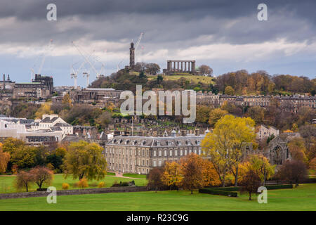 Trees display autumn colours amongst the buildings and parks of Edinburgh city, including Holyrood Palace and Abbey, the Scottish Parliament buildings Stock Photo