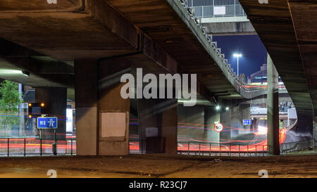Glasgow, Scotland, UK - November 6, 2018: Traffic leaves light trails amongst a tangle of concrete flyovers and slipway roads at the M8 motorway Ander Stock Photo