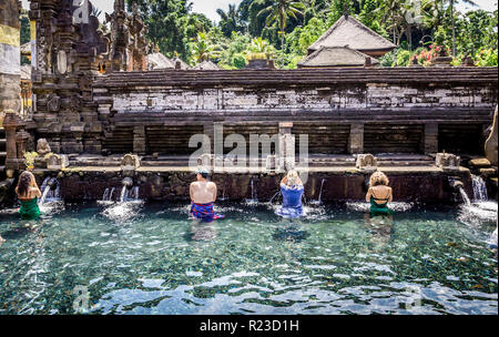 BALI, INDONESIA - APRIL 23, 2018: Tourists taking bath at Holy Spring Water Tirta Empul Hindu Temple on Bali island in Indonesia Stock Photo