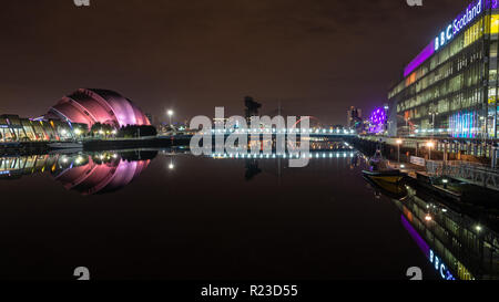 Glasgow, Scotland, UK - November 4, 2018: The River Clyde flows past the Finnieston Crane, BBC Scotland studios and SEC Armadillo Auditorium at night 