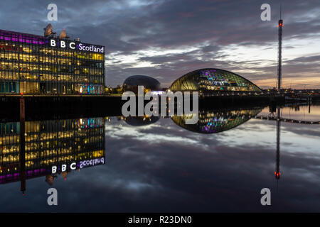 Glasgow, Scotland, UK - November 4, 2018: The modern offices and studios of BBC Scotland, and the Scottish Science Centre and Tower, are lit at night  Stock Photo