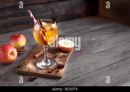 Hard apple cider (sangria, punch, fruit wine) for autumn and winter holidays - homemade festive Christmas, Thanksgiving drink on wooden table, copy sp Stock Photo