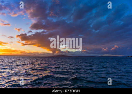 Majestic  colorful clouds hang above the Puget Sound. Photo take from West Seattle, Washington. Stock Photo