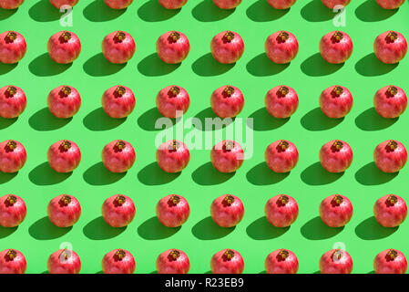 Pomegranate pattern on green background. Hard light, text space Stock Photo