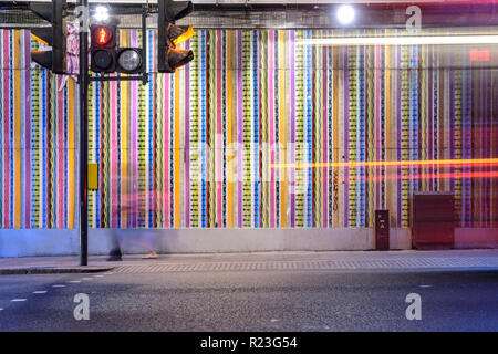 London, England, UK - October 7, 2018: Pedestrians cross Ladbroke Grove road at a pelican crossing beneath the Hammersmith and City London Underground Stock Photo