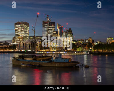 London, England, UK - September 27, 2018: Skyscrapers and office blocks of the City of London financial district are lit up at night, including 22 Bis Stock Photo