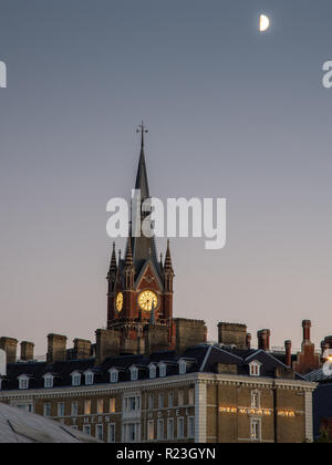 London, England, UK - September 17, 2018: A half moon rises above the gothic spire of St Pancras International Railway Station and Great Northern Hote