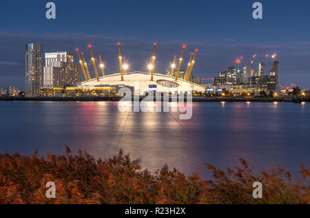 London, England, UK - September 14, 2018: The O2 Arena Millennium Dome and modern skyscraper apartment buildings are lit up on the redeveloped North G