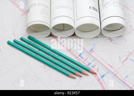 Architectural plans lying on drawing board with green pencils Stock Photo