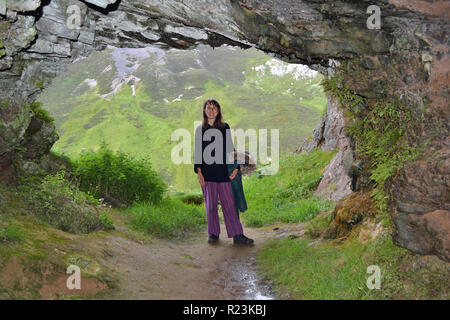 Lady in Bone Caves at Dusk. Ullapool, Scotland, UK Stock Photo