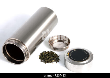 Chinese personal thermos with green tea leafs for traditional chinese drink isolated on white Stock Photo