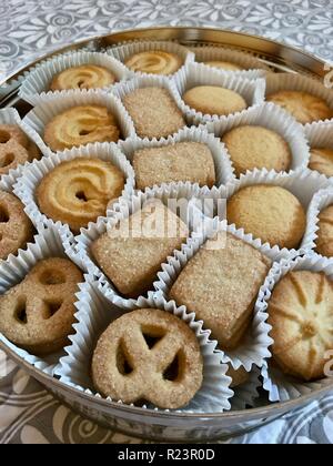 A mixture of Christmas butter biscuits in a tin Stock Photo