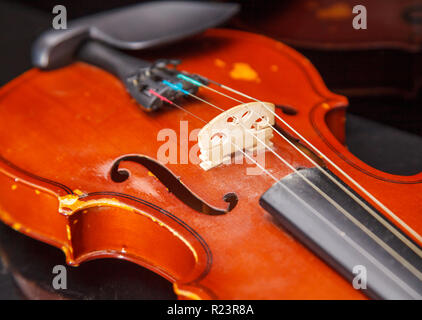 brown vintage violin lying on a table closeup indoor Stock Photo