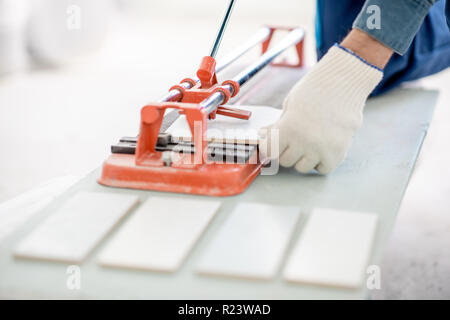 Close-up of a man cutting ceramic tiles with handy machine Stock Photo