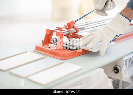 Close-up of a man cutting ceramic tiles with handy machine Stock Photo