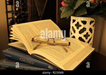 Dog eared Jane Austen with glasses Stock Photo