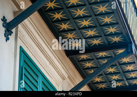 oldfashioned wooden balcony blue with golden stars green shutters Stock Photo