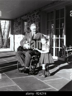 Franklin D. Roosevelt with Fala his dog and Ruthie Bie in Hyde Park, New York, 1941. There were few images taken showing President Roosevelt in his wheelchair. Stock Photo