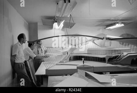 architect Eero Saarinen, 1910-1961, studies a scale model of the Trans World Airlines Terminal, John F. Kennedy (originally Idlewild) Airport, New York, New York, 1956-62. Stock Photo