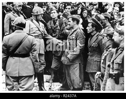 Benito Mussolini (1883-1945) Italian politician, journalist, and leader of the National Fascist Party greeting war veterans circa 1939 Stock Photo