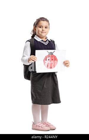 Full length portrait of a little schoolgirl holding a drawing with a ladybug isolated on white background Stock Photo