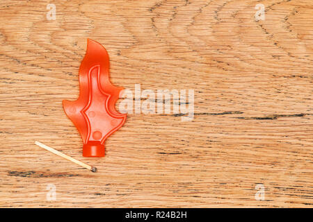 imitation of a burning match on an old wooden table Stock Photo