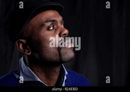 Black business man overturned hat, black background Stock Photo