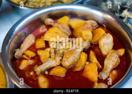 Fresh prepared spicy red massaman curry with chicken and potatoes on local market in Bangkok. Traditional thai cuisine made of fresh ingredients. Stock Photo