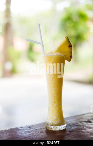 Fresh prepared sweet ice cold pineapple shake in local restaurant on Koh Mook island. Traditional thai cuisine made of fresh ingredients. Stock Photo