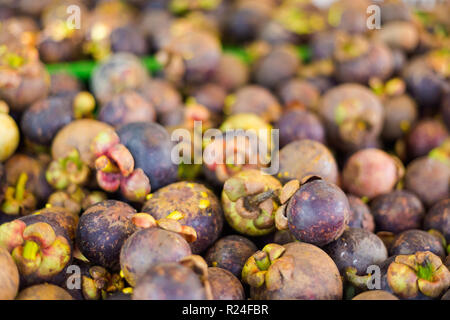 Fresh sweet mangosteen fruits on local market in Krabi town. Traditional thai fresh food. Stock Photo