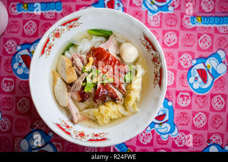 Fresh prepared asian aromatic duck broth soup with dimsum dumplings, pork meat balls and noodles in local restaurant on koh Lanta island. Traditional  Stock Photo