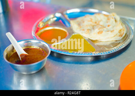 Fresh prepared malaysian roti pancake and dhal breakfast set served in local restaurant in Cameron Highlands. Traditional asian cuisine made of fresh  Stock Photo