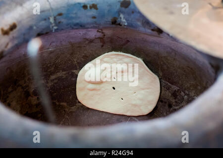 Fresh malaysian tandoori naan bread baking in indian oven in local restaurant in Cameron Highlands. Traditional asian cuisine made of fresh ingredient Stock Photo