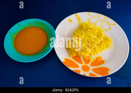 Fresh prepared malaysian roti jala pancake and dhal breakfast set served in local restaurant on Penang island. Traditional asian cuisine made of fresh Stock Photo