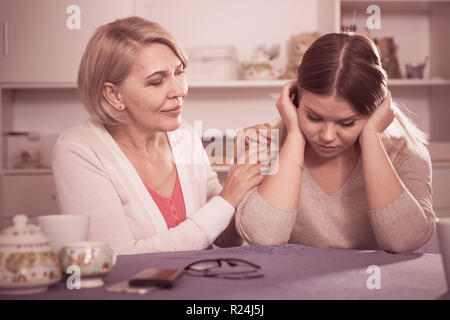 Kind mother comforts and supports her adult daughter after failure Stock Photo