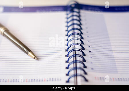 Pen on a spiral diary agenda. Business and time schedule concept Stock Photo