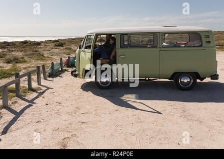Couple using mobile phone in vehicle Stock Photo
