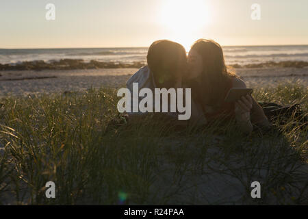 Couple kissing on the beach Stock Photo