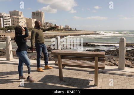 Couple holding hands on promenade Stock Photo