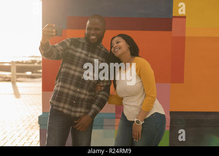 Couple taking selfie on promenade Stock Photo