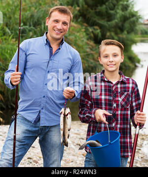 Father And Son Fishing Boy Holding Up Fish Smiling Portrait High