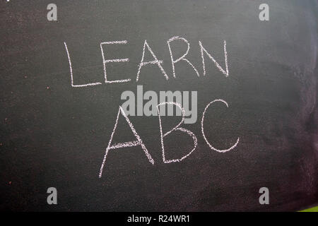 Green school chalkboard. School table. Back to school. School chalkboard with note. Stock Photo