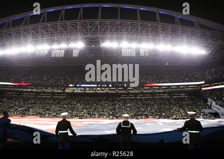 Seattle, WA, USA. 15th Nov, 2018. Members of the United States armed services hold the American flag in front of fans before a game between the Green Bay Packers and Seattle Seahawks at CenturyLink Field in Seattle, WA. Seahawks defeat the Packers 27-24. Sean Brown/CSM/Alamy Live News
