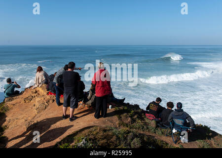 People seen watching the first stage of the World Surf League. The first stage (Nazaré Challenge) of the World Surf League (WSL) Big Wave Tour took place in Nazaré, Portugal. South African surfer Grant Baker won the Portuguese competition. Stock Photo