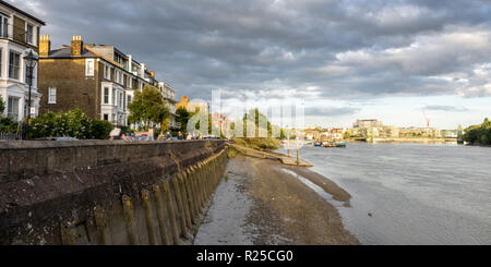 London, England, UK - September 9, 2018: Houses stand on Upper Mall in Hammersmith, overlooking the Thames Path and River Thames, with Hammersmith Bri Stock Photo